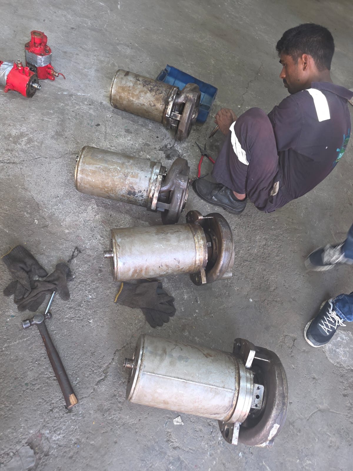 Technician working beside dismantled FRAMO pumps