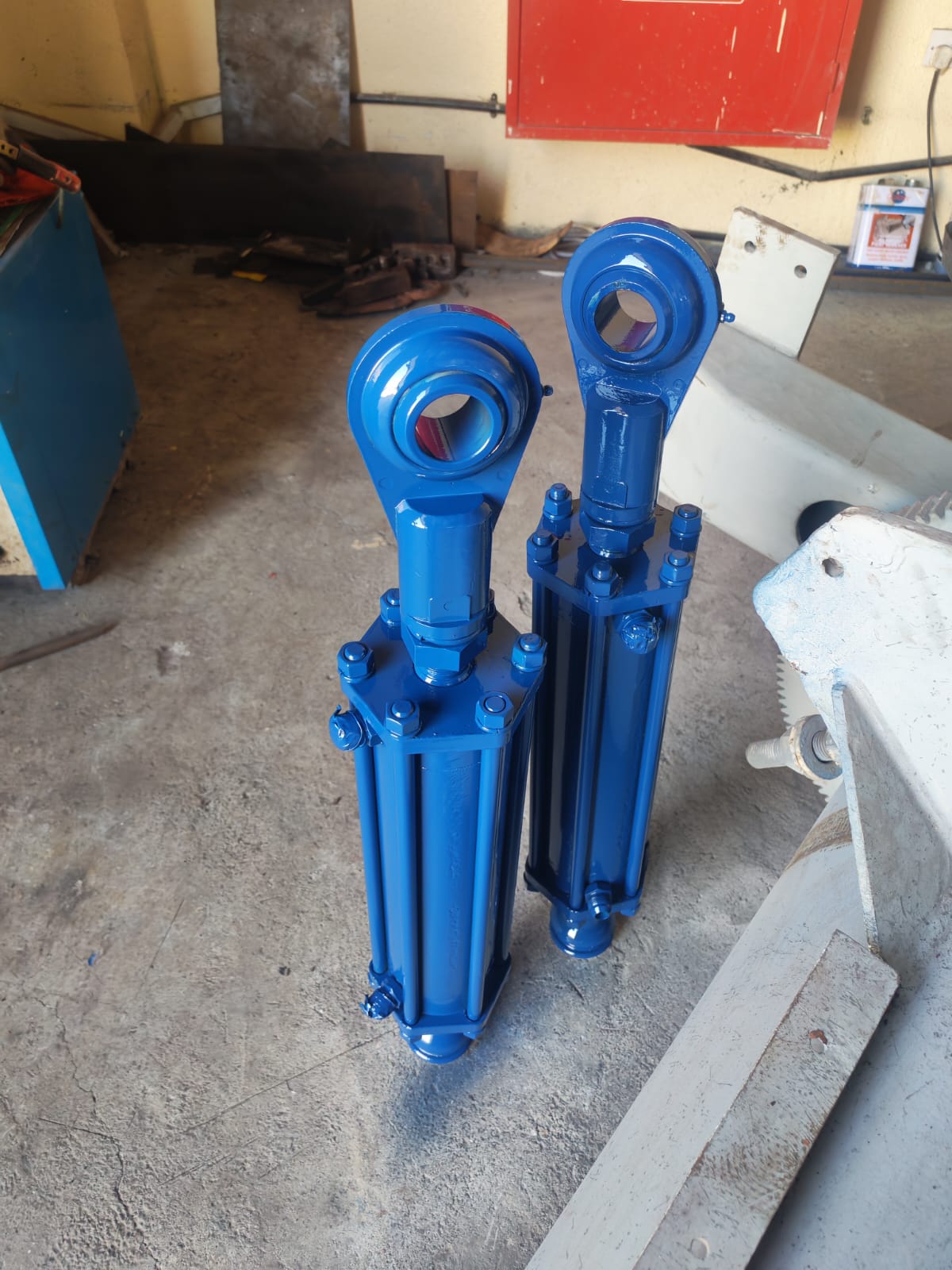Two blue steering gear hydraulic cylinders at the workshop
